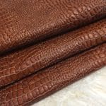 The crocodile-embossed cow full grain leather is a great choice for DIY leather projects such as arts and crafts, jewelry, leather earrings, leather bracelets, wallets, small leather goods, and patchwork. The inspirational idea will be the key. This leather is chrome-tanned and has a soft to medium temper. It has an average hide size of 4-9 sq. ft. and a thickness of 3 oz (1.0-1.2 mm). It may have some holes or defects, but it is free of PCP, Azo pigments, Chrome VI, Formaldehyde, and APEO. To save on shipping costs, the leather is folded and inserted into a padded envelope. If you want to avoid creases due to folding, please contact us for special handling.
