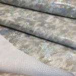 This Metallic Snake Embossed Lambskin collection is a beautiful snakeskin printed hide with a combination of neutral and metallic colors. The leather itself is slightly textured with a bit of a stretch and a soft surface. The surface also has a slight sheen to it that really brings out all the colors throughout. This eye-catching leather has a unique, yet sophisticated look that possesses modern-day fashion.