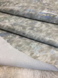 This Metallic Snake Embossed Lambskin collection is a beautiful snakeskin printed hide with a combination of neutral and metallic colors. The leather itself is slightly textured with a bit of a stretch and a soft surface. The surface also has a slight sheen to it that really brings out all the colors throughout. This eye-catching leather has a unique, yet sophisticated look that possesses modern-day fashion.