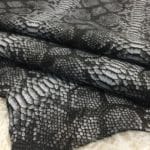 This Lambskin leather is a stunning hide printed with a captivating snakeskin pattern, featuring an alluring combination of exotic colors that sets it apart from other leathers. The leather has a slightly textured surface with a bit of stretch, making it highly versatile for various projects. This leather has a unique yet sophisticated appearance that complements modern fashion trends, making it a highly sought-after item in the fashion industry. It is highly versatile and perfect for creating a range of products such as apparel, wallets, accessories, handbags, shoes, and more. Its unique texture, pattern, and color combination make it an ideal choice for designers looking to create high-quality, fashionable products. This leather is made from high-quality Lambskin and features a unique snake print pattern that is highly desirable in the fashion industry. The leather is tanned using the Chrome tanning process, which gives it a unique texture and added durability. The average hide size is 7 square feet, making it perfect for creating a range of products, and the leather thickness ranges from 0.7 to 0.9 mm, giving it a soft and supple feel. The leather is sourced from Turkey, which is known for producing high-quality leathers that are sought after by designers around the world.