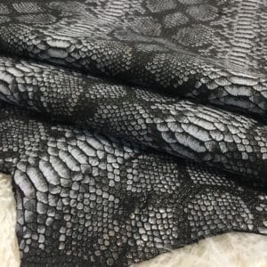 This Lambskin leather is a stunning hide printed with a captivating snakeskin pattern, featuring an alluring combination of exotic colors that sets it apart from other leathers. The leather has a slightly textured surface with a bit of stretch, making it highly versatile for various projects. This leather has a unique yet sophisticated appearance that complements modern fashion trends, making it a highly sought-after item in the fashion industry. It is highly versatile and perfect for creating a range of products such as apparel, wallets, accessories, handbags, shoes, and more. Its unique texture, pattern, and color combination make it an ideal choice for designers looking to create high-quality, fashionable products. This leather is made from high-quality Lambskin and features a unique snake print pattern that is highly desirable in the fashion industry. The leather is tanned using the Chrome tanning process, which gives it a unique texture and added durability. The average hide size is 7 square feet, making it perfect for creating a range of products, and the leather thickness ranges from 0.7 to 0.9 mm, giving it a soft and supple feel. The leather is sourced from Turkey, which is known for producing high-quality leathers that are sought after by designers around the world.