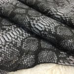 This Lambskin leather is a stunning hide printed with a captivating snakeskin pattern, featuring an alluring combination of exotic colors that sets it apart from other leathers. The leather has a slightly textured surface with a bit of stretch, making it highly versatile for various projects. This leather has a unique yet sophisticated appearance that complements modern fashion trends, making it a highly sought-after item in the fashion industry. It is highly versatile and perfect for creating a range of products such as apparel, wallets, accessories, handbags, shoes, and more. Its unique texture, pattern, and color combination make it an ideal choice for designers looking to create high-quality, fashionable products. This leather is made from high-quality Lambskin and features a unique snake print pattern that is highly desirable in the fashion industry. The leather is tanned using the Chrome tanning process, which gives it a unique texture and added durability. The average hide size is 7 square feet, making it perfect for creating a range of products, and the leather thickness ranges from 0.7 to 0.9 mm, giving it a soft and supple feel. The leather is sourced from Turkey, which is known for producing high-quality leathers that are sought after by designers around the world.