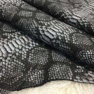 This Lambskin leather is a stunning hide printed with a captivating snakeskin pattern, featuring an alluring combination of exotic colors that sets it apart from other leathers. The leather has a slightly textured surface with a bit of stretch, making it highly versatile for various projects. This leather has a unique yet sophisticated appearance that complements modern fashion trends, making it a highly sought-after item in the fashion industry. It is highly versatile and perfect for creating a range of products such as apparel, wallets, accessories, handbags, shoes, and more. Its unique texture, pattern, and color combination make it an ideal choice for designers looking to create high-quality, fashionable products. This leather is made from high-quality Lambskin and features a unique snake print pattern that is highly desirable in the fashion industry. The leather is tanned using the Chrome tanning process, which gives it a unique texture and added durability. The average hide size is 7 square feet, making it perfect for creating a range of products, and the leather thickness ranges from 0.7 to 0.9 mm, giving it a soft and supple feel. The leather is sourced from Turkey, which is known for producing high-quality leathers that are sought after by designers around the world.