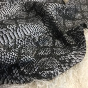 This Lambskin leather is a stunning hide printed with a captivating snakeskin pattern, featuring an alluring combination of exotic colors that sets it apart from other leathers. The leather has a slightly textured surface with a bit of stretch, making it highly versatile for various projects. This leather has a unique yet sophisticated appearance that complements modern fashion trends, making it a highly sought-after item in the fashion industry. It is highly versatile and perfect for creating a range of products such as apparel, wallets, accessories, handbags, shoes, and more. Its unique texture, pattern, and color combination make it an ideal choice for designers looking to create high-quality, fashionable products. This leather is made from high-quality Lambskin and features a unique snake print pattern that is highly desirable in the fashion industry. The leather is tanned using the Chrome tanning process, which gives it a unique texture and added durability. The average hide size is 7 square feet, making it perfect for creating a range of products, and the leather thickness ranges from 0.7 to 0.9 mm, giving it a soft and supple feel. The leather is sourced from Turkey, which is known for producing high-quality leathers that are sought after by designers around the world.