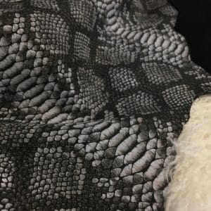 This Lambskin leather is a stunning hide printed with a captivating snakeskin pattern, featuring an alluring combination of exotic colors that sets it apart from other leathers. The leather has a slightly textured surface with a bit of stretch, making it highly versatile for various projects. This leather has a unique yet sophisticated appearance that complements modern fashion trends, making it a highly sought-after item in the fashion industry. It is highly versatile and perfect for creating a range of products such as apparel, wallets, accessories, handbags, shoes, and more. Its unique texture, pattern, and color combination make it an ideal choice for designers looking to create high-quality, fashionable products. This leather is made from high-quality Lambskin and features a unique snake print pattern that is highly desirable in the fashion industry. The leather is tanned using the Chrome tanning process, which gives it a unique texture and added durability. The average hide size is 7 square feet, making it perfect for creating a range of products, and the leather thickness ranges from 0.7 to 0.9 mm, giving it a soft and supple feel. The leather is sourced from Turkey, which is known for producing high-quality leathers that are sought after by designers around the world.