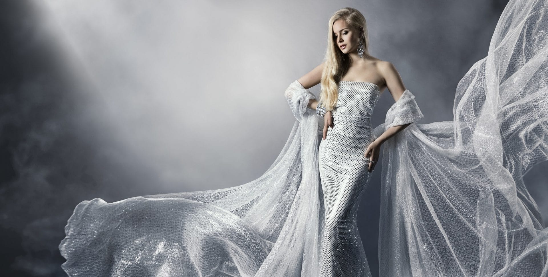 "Elegant woman in shimmering white gown representing fashion and style."