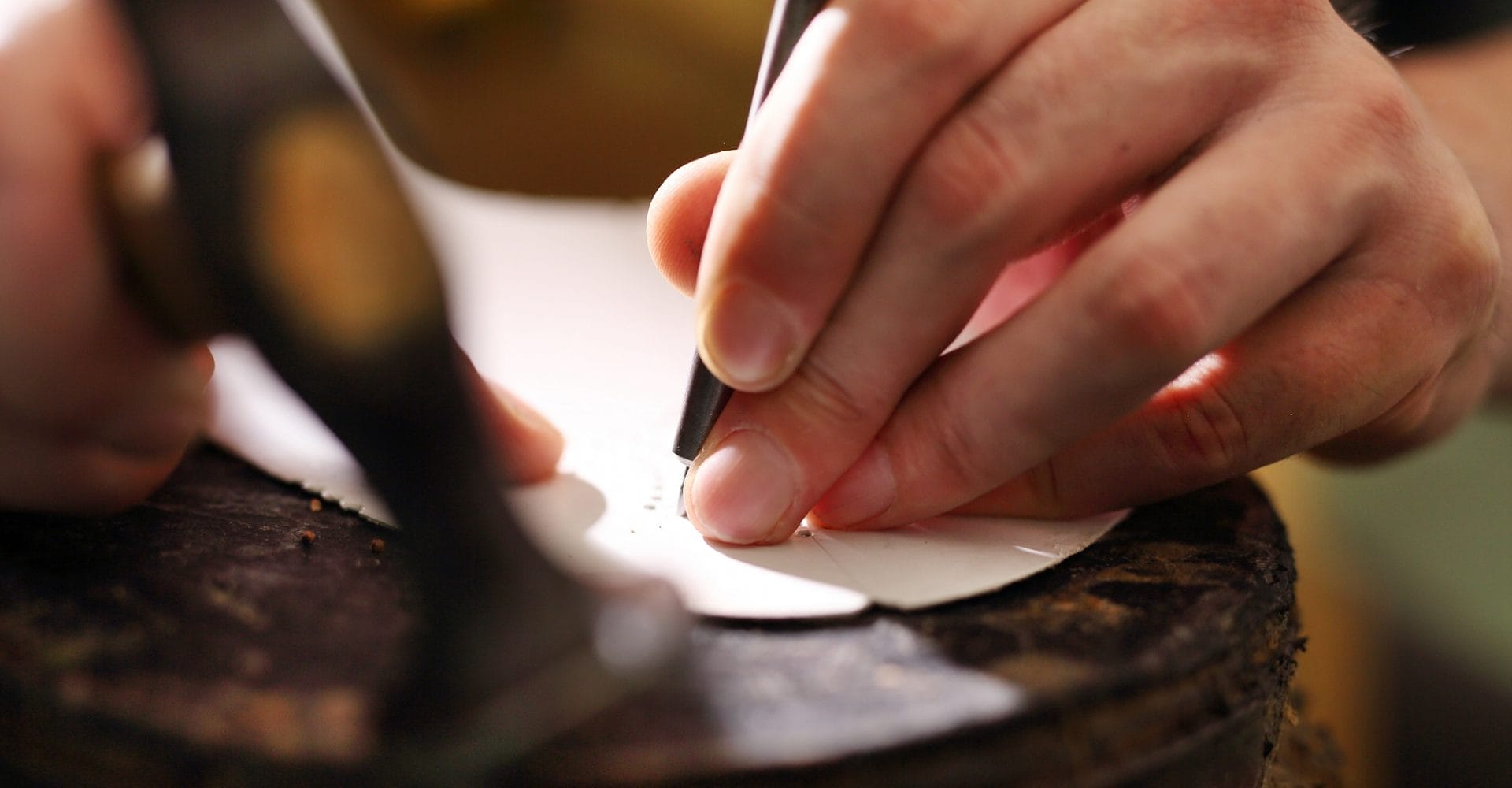 "Artisan handcrafting fine leather accessories with traditional tools."