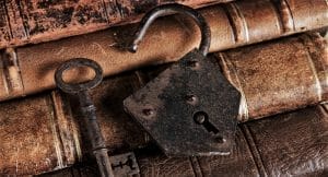 Vintage leather-bound books with antique lock and key, symbolizing timeless fashion – Avetco Inc. banner 23