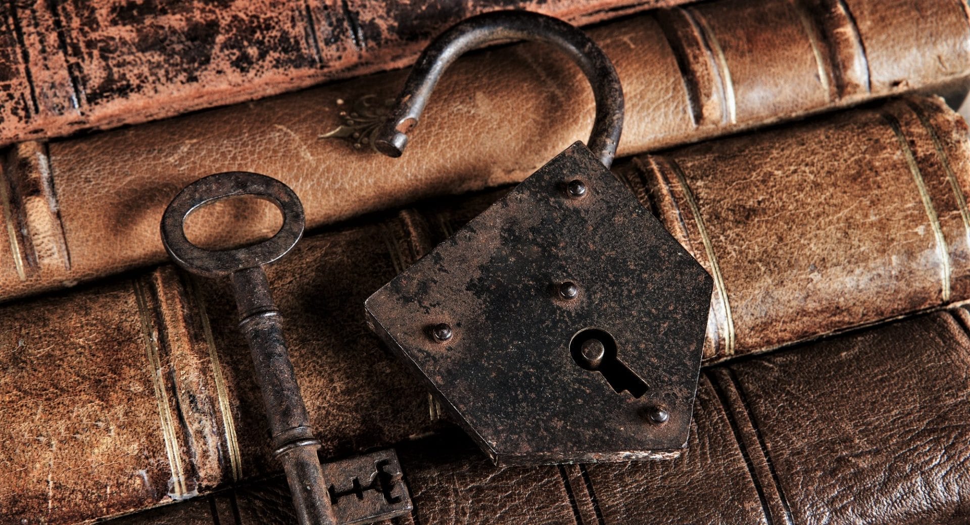 "Vintage leather-bound books with antique lock and key, symbolizing timeless fashion."