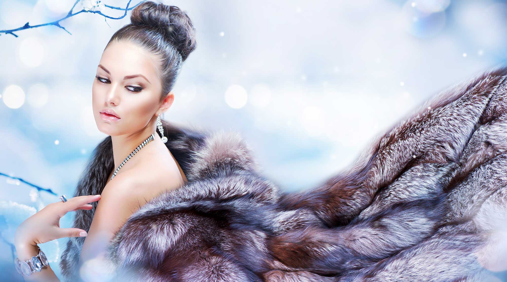 Elegant fashion model in fur coat with leather accents and jewelry accessories