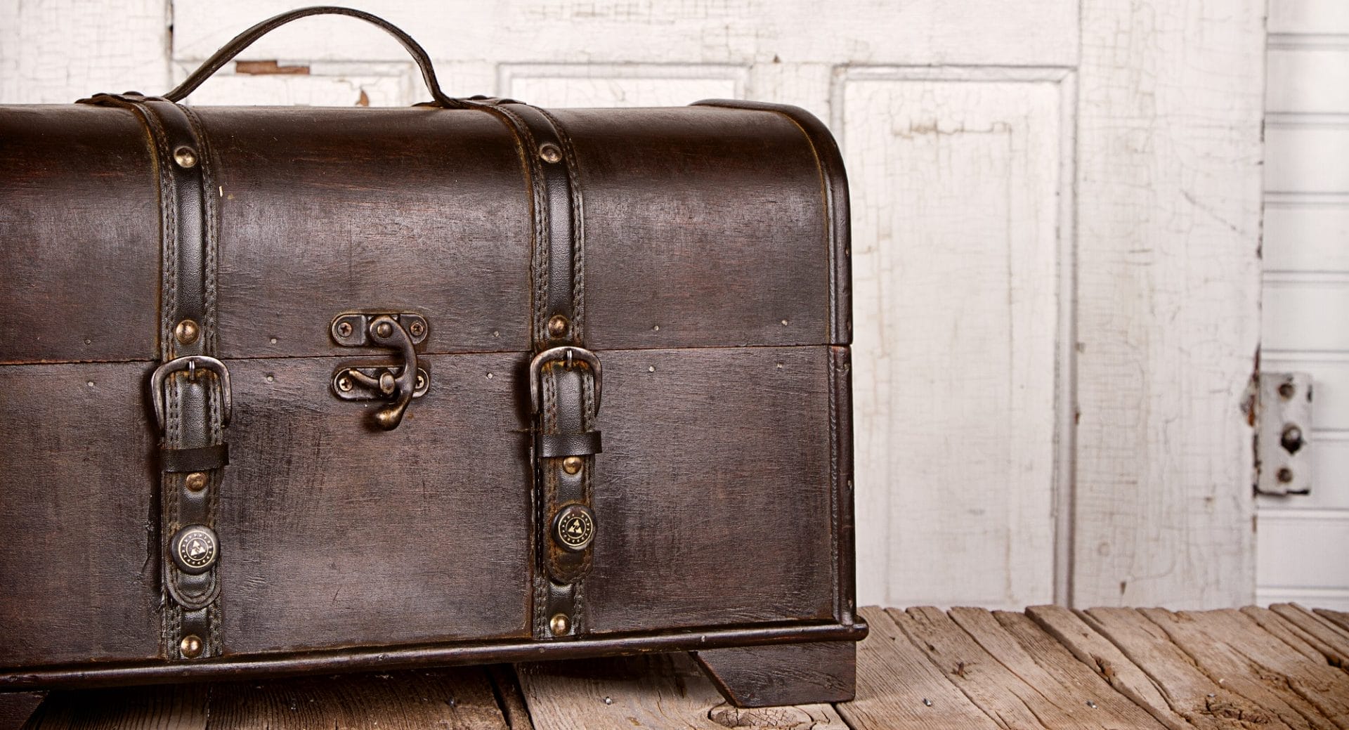 Vintage leather chest with fashion-inspired metal accessories