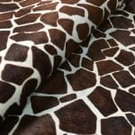 This chestnut cowhide features a bold giraffe print, offering a unique, exotic touch to any project. Perfect for handbags, upholstery, footwear, garments, pillows, and décor. Printed on premium hair-on cowhide for durability and natural texture with a wild, stylish edge. Each hide is one-of-a-kind—ideal for standout fashion and interior designs.