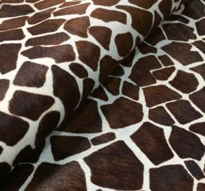 This chestnut cowhide features a bold giraffe print, offering a unique, exotic touch to any project. Perfect for handbags, upholstery, footwear, garments, pillows, and décor. Printed on premium hair-on cowhide for durability and natural texture with a wild, stylish edge. Each hide is one-of-a-kind—ideal for standout fashion and interior designs.