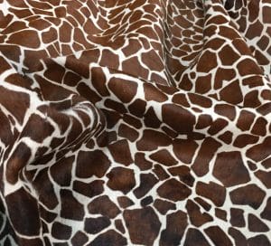 This chestnut cowhide features a bold giraffe print, offering a unique, exotic touch to any project. Perfect for handbags, upholstery, footwear, garments, pillows, and décor. Printed on premium hair-on cowhide for durability and natural texture with a wild, stylish edge. Each hide is one-of-a-kind—ideal for standout fashion and interior designs.