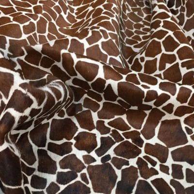 This chestnut cowhide features a bold giraffe print, offering a unique, exotic touch to any project. Perfect for handbags, upholstery, footwear, garments, pillows, and décor. Printed on premium hair-on cowhide for durability and natural texture with a wild, stylish edge. Each hide is one-of-a-kind—ideal for standout fashion and interior designs.