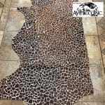 This chestnut cowhide features a bold giraffe print, offering a unique, exotic touch to any project. Perfect for handbags, upholstery, footwear, garments, pillows, and décor. Printed on premium hair-on cowhide for durability and natural texture with a wild, stylish edge. Each hide is one-of-a-kind—ideal for standout fashion and interior designs.