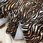 Cowhide with striking black and brown zebra print. Ideal for handbags, shoes, garments, upholstery, pillows, and décor. Natural, bold, and stylish finish.