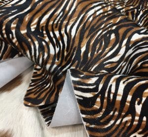 Cowhide with striking black and brown zebra print. Ideal for handbags, shoes, garments, upholstery, pillows, and décor. Natural, bold, and stylish finish.