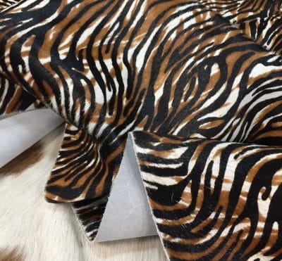 Cowhide with striking black and brown zebra print. Ideal for handbags, shoes, garments, upholstery, pillows, and décor. Natural, bold, and stylish finish.