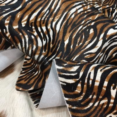 Cowhide with striking black and brown zebra print. Ideal for handbags, shoes, garments, upholstery, pillows, and décor. Natural, bold, and stylish finish.