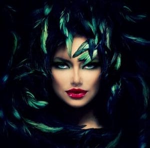 "High fashion look with dark feather accessories and bold leather elements"