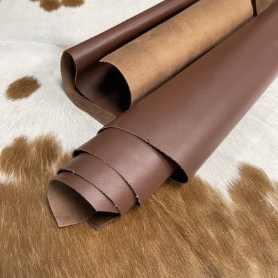 The Europa Bitter Chocolate cow leather has exceptional durability and longevity. The full-grain cowhide leather, sourced exclusively from the side of the cow, is impressively thick at 3/4 oz. (1.2-1.4mm) and has undergone chrome tannage, resulting in a soft to medium temper. These hides typically measure 16-18 sq. ft. and are sourced from Mexico. This Leather is suitable for a variety of products, including handbags, belts, shoes, straps, and accessories.