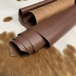 The Europa Bitter Chocolate cow leather has exceptional durability and longevity. The full-grain cowhide leather, sourced exclusively from the side of the cow, is impressively thick at 3/4 oz. (1.2-1.4mm) and has undergone chrome tannage, resulting in a soft to medium temper. These hides typically measure 16-18 sq. ft. and are sourced from Mexico. This Leather is suitable for a variety of products, including handbags, belts, shoes, straps, and accessories.