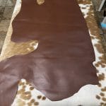 The Europa Bitter Chocolate cow leather has exceptional durability and longevity. The full-grain cowhide leather, sourced exclusively from the side of the cow, is impressively thick at 3/4 oz. (1.2-1.4mm) and has undergone chrome tannage, resulting in a soft to medium temper. These hides typically measure 16-18 sq. ft. and are sourced from Mexico. This Leather is suitable for a variety of products, including handbags, belts, shoes, straps, and accessories.