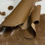 The Europa cow leather has exceptional durability and longevity. The full-grain cowhide, sourced exclusively from the side of the cow, is impressively thick at 3/4 oz. (1.2-1.4mm) and has undergone chrome tannage, resulting in a soft to medium temper. These hides typically measure 16-18 sq. ft. and are sourced from Mexico. This Leather is suitable for a variety of products, including handbags, belts, shoes, straps, and accessories.