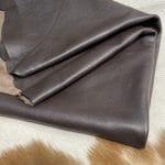 The Hudson Cow Leather Collection showcases exquisite cowhide items crafted from top-quality full-grain leather. These products are highly durable and built to last. With a timeless and exquisite appearance, the leather boasts a natural grain texture and is 1.0-1.2 mm thick. Its medium-soft temper feels silky smooth against the skin. These versatile products can be used for hats, wallets, handbags, shoes, accessories, and apparel. Every hide is approximately 18-20 sq. ft. and has a sleek chrome finish.