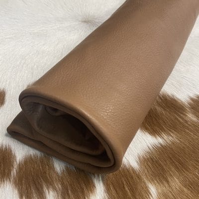 The Hudson Cow Leather Collection showcases exquisite cowhide items crafted from top-quality full-grain leather. These products are highly durable and built to last. With a timeless and exquisite appearance, the leather boasts a natural grain texture and is 1.0-1.2 mm thick. Its medium-soft temper feels silky smooth against the skin. These versatile products can be used for hats, wallets, handbags, shoes, accessories, and apparel. Every hide is approximately 18-20 sq. ft. and has a sleek chrome finish.
