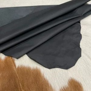 This high-quality lambskin garment leather is made from 100% British lambskin, renowned for its soft and supple texture. The leather is expertly tanned using the chrome tanning process, which results in a durable and long-lasting product that will wear beautifully over time. The leather is available in a full hide size of 5-7 sq. ft. and has a full-grain finish, which means that it retains the natural texture and markings of the original hide. The thickness of the leather is 1 oz, which equates to a range of 0.4-0.6 mm. The leather is sourced from Turkey, where it undergoes rigorous quality control procedures to ensure that it meets the highest standards. The resulting product is a premium-grade leather that is perfect for creating luxurious garments and accessories that will stand the test of time.