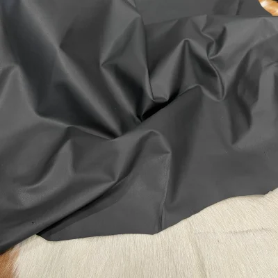 This high-quality lambskin garment leather is made from 100% British lambskin, renowned for its soft and supple texture. The leather is expertly tanned using the chrome tanning process, which results in a durable and long-lasting product that will wear beautifully over time. The leather is available in a full hide size of 5-7 sq. ft. and has a full-grain finish, which means that it retains the natural texture and markings of the original hide. The thickness of the leather is 1 oz, which equates to a range of 0.4-0.6 mm. The leather is sourced from Turkey, where it undergoes rigorous quality control procedures to ensure that it meets the highest standards. The resulting product is a premium-grade leather that is perfect for creating luxurious garments and accessories that will stand the test of time.