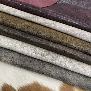 The Oklahoma collection leather is not just about its unique crackle finish and vintage look. It's also a testament to durability. Crafted from chrome-tanned heifer hide, it's been dyed-through to create a soft, suede base with a shiny wax transfer on top. This gives the leather a vintage, yet timeless look that's perfect for a variety of uses, including accessories like handbags, wallets, belts, and footwear. Its textured and strong appearance is a clear indication of its durability, making it an excellent choice for apparel and trim. The leather has an aniline finishing which gives it a rugged appearance. It is available in a weight of 3 oz. (1.2-1.4 mm) and has an average hide size of 22-25 Sq. Ft. It is tanned in Mexico and has a soft temper with a dull shine. We understand that the measurements of the leather can vary, and we want to assure you that your order is an estimate. The final cost will be determined once the hide is ready to ship. You will be refunded the difference if the leather is smaller than specified. This way, you can feel secure in your purchase and confident that you're getting the best value for your money.