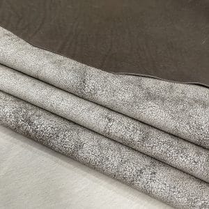 The Oklahoma collection leather is not just about its unique crackle finish and vintage look. It's also a testament to durability. Crafted from chrome-tanned heifer hide, it's been dyed-through to create a soft, suede base with a shiny wax transfer on top. This gives the leather a vintage, yet timeless look that's perfect for a variety of uses, including accessories like handbags, wallets, belts, and footwear. Its textured and strong appearance is a clear indication of its durability, making it an excellent choice for apparel and trim. The leather has an aniline finishing which gives it a rugged appearance. It is available in a weight of 3 oz. (1.2-1.4 mm) and has an average hide size of 22-25 Sq. Ft. It is tanned in Mexico and has a soft temper with a dull shine.