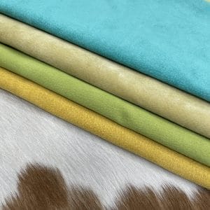 Economy Pig Suede Leather offers a unique, distinct look with characteristics that do not affect its performance. It may have uneven shade tones, dark spots, scarring, and a few holes, giving it an individualized appearance. This soft leather is made from swine raw material, weighing 2 oz. (0.6-0.8 mm) and is available in whole-hide specification. Despite minor blemishes and/or holes, it provides a soft and luxurious texture. With an average hide size of 3-9 sq. ft., it is suitable for lining in accessories, arts and crafts, bookbinding, shoes, and small leather goods.