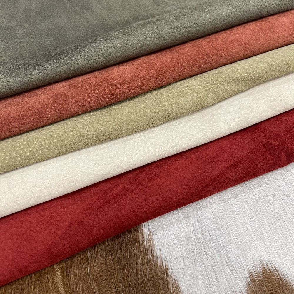 Redgreeneggshell brick 4 Economy Pig Suede Leather offers a unique, distinct look with characteristics that do not affect its performance. It may have uneven shade tones, dark spots, scarring, and a few holes, giving it an individualized appearance. This soft leather is made from swine raw material, weighing 2 oz. (0.6-0.8 mm) and is available in whole-hide specification. Despite minor blemishes and/or holes, it provides a soft and luxurious texture. With an average hide size of 3-9 sq. ft., it is suitable for lining in accessories, arts and crafts, bookbinding, shoes, and small leather goods.