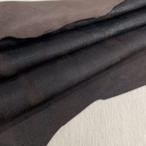 Our Montana Lambskin features a unique distressed look with a blend of earthy tones, including red, brown, black, and cognac. Its soft texture and rugged finish make it perfect for fashion pieces that need a worn-in, vintage appeal. Ideal for high-end accessories, garments, and décor, this leather offers both style and durability.