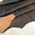 Our Montana Lambskin features a unique distressed look with a blend of earthy tones, including red, brown, black, and cognac. Its soft texture and rugged finish make it perfect for fashion pieces that need a worn-in, vintage appeal. Ideal for high-end accessories, garments, and décor, this leather offers both style and durability.