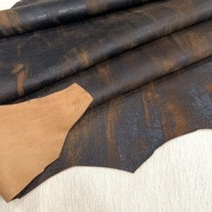 Our Montana Lambskin features a unique distressed look with a blend of earthy tones, including red, brown, black, and cognac. Its soft texture and rugged finish make it perfect for fashion pieces that need a worn-in, vintage appeal. Ideal for high-end accessories, garments, and décor, this leather offers both style and durability.