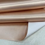 Bonded polyester satin with tricot backing, 58" wide, 0.3 mm thick. Available in Black, Champagne, Rose, Beige Copper, Bronze Red & Silver.