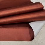Bonded polyester satin with tricot backing, 58" wide, 0.3 mm thick. Available in Black, Champagne, Rose, Beige Copper, Bronze Red & Silver.