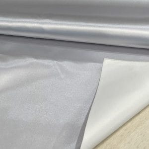 Bonded polyester satin with tricot backing, 58" wide, 0.3 mm thick. Available in Black, Champagne, Rose, Beige Copper, Bronze Red & Silver.