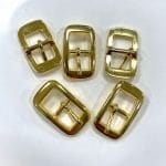 Close-up of Y1018 Center Bar Buckle in Gold finish, made of zinc alloy, designed for straps. Compact, rectangular design with a center bar, photographed on a neutral background.