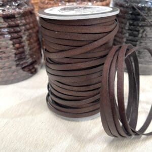 Vintage brown and tan flat veg-tan leather cords coiled and displayed