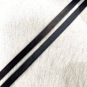 Close-up of 8mm wide flat leather cords in vintage black and brown