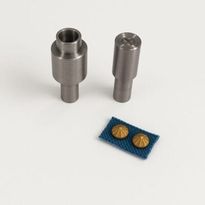 Die setter tool set for 9mm NH72 parachute nailhead, shown with a brass nailhead installed on blue fabric, designed for precise and damage-free application.