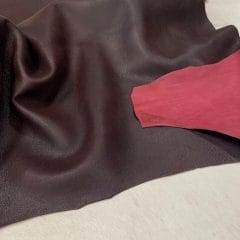 black-crackle-cordovan-base-flexedjpg | Avetco Leather Hides and Eva Foam Black crackle leather with rich cordovan red base, smooth distressed finish visible in flat, unflexed state.