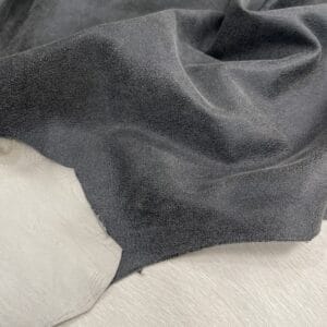 Black crackle leather with subtle pebble texture and off-white base, shown flat to highlight topcoat finish.