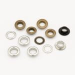 8.8mm EL2 beveled grommets in Antique Brass and Nickel finishes with matching washers, arranged on a white background.-Avetco